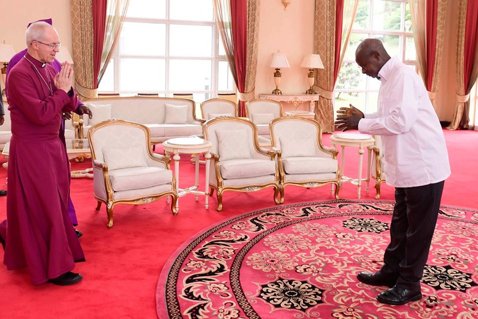 President Yoweri Museveni uses hand gestures to greet the Archbishop of Canterbury, Justin Portal Welby at State House