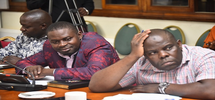 Hon. Mpindi Bumali (R) closely follows the proceedings of the committee