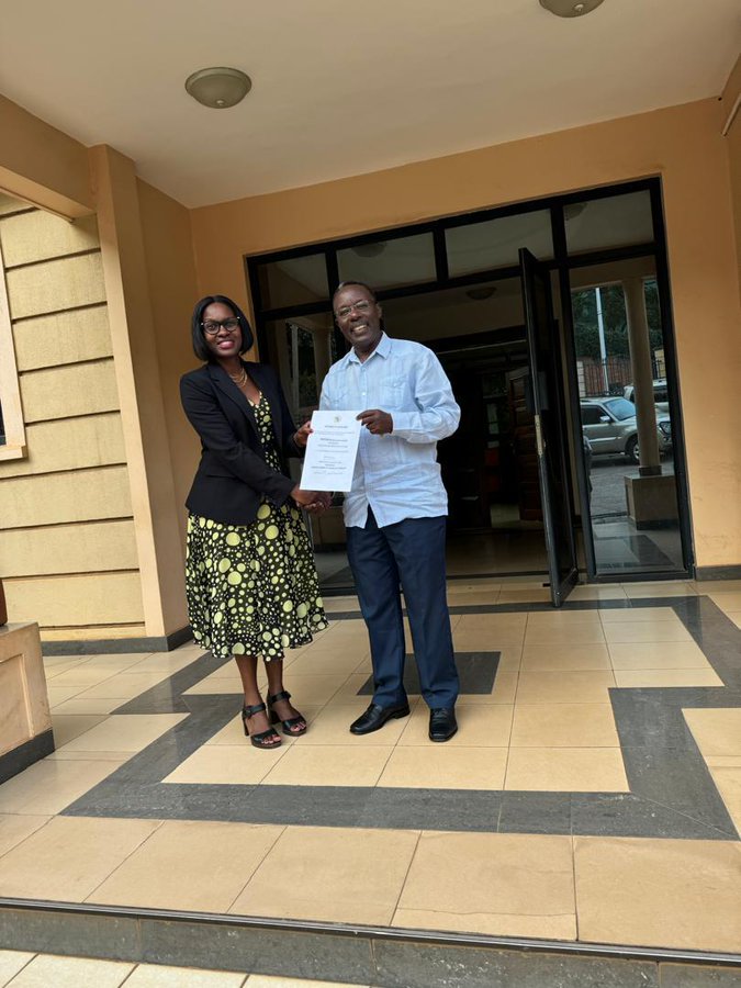 MUST Council Chair Dr. Warren Naamara handing over the instrument of appointment to incoming MUST  Vice Chancellor.