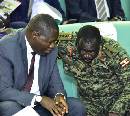 The Deputy Chief of Defence Forces, Gen Peter Elwelu (R) consults State minister for Defence, Oboth Oboth during plenary