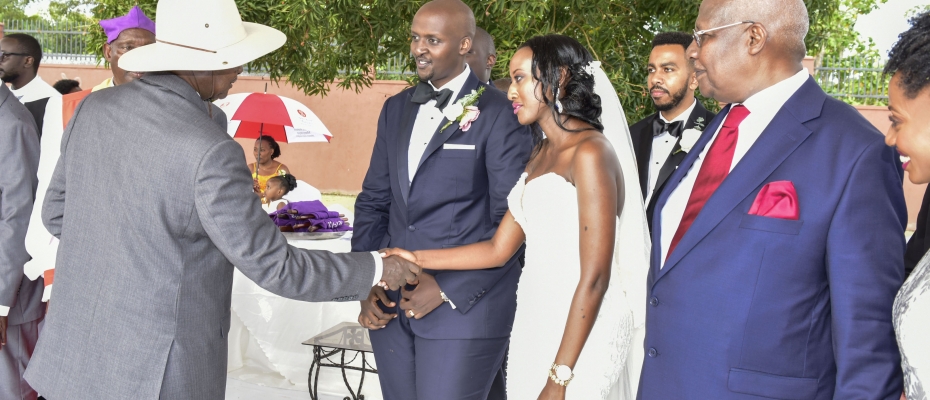 President Museveni shares a light moment with Isaac Kutesa and his wife Yvette after their wedding at Munyonyo on Saturday. Looking on (R) is Hon Sam Kutesa, father to the groom