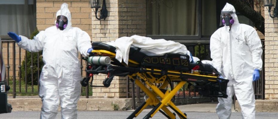 Workers wearing protective gear remove bodies of people who have died from COVID-19 from a New Jersey nursing home morgue