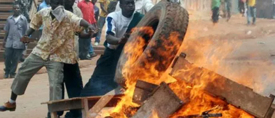Rioters burn tyres and wood in Kampala. 