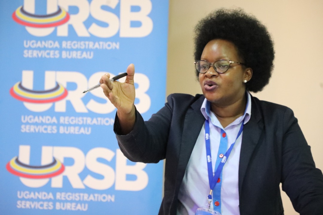 The Registrar General Mercy Kainobwisho gestures during the GI consultative meeting in Kampala