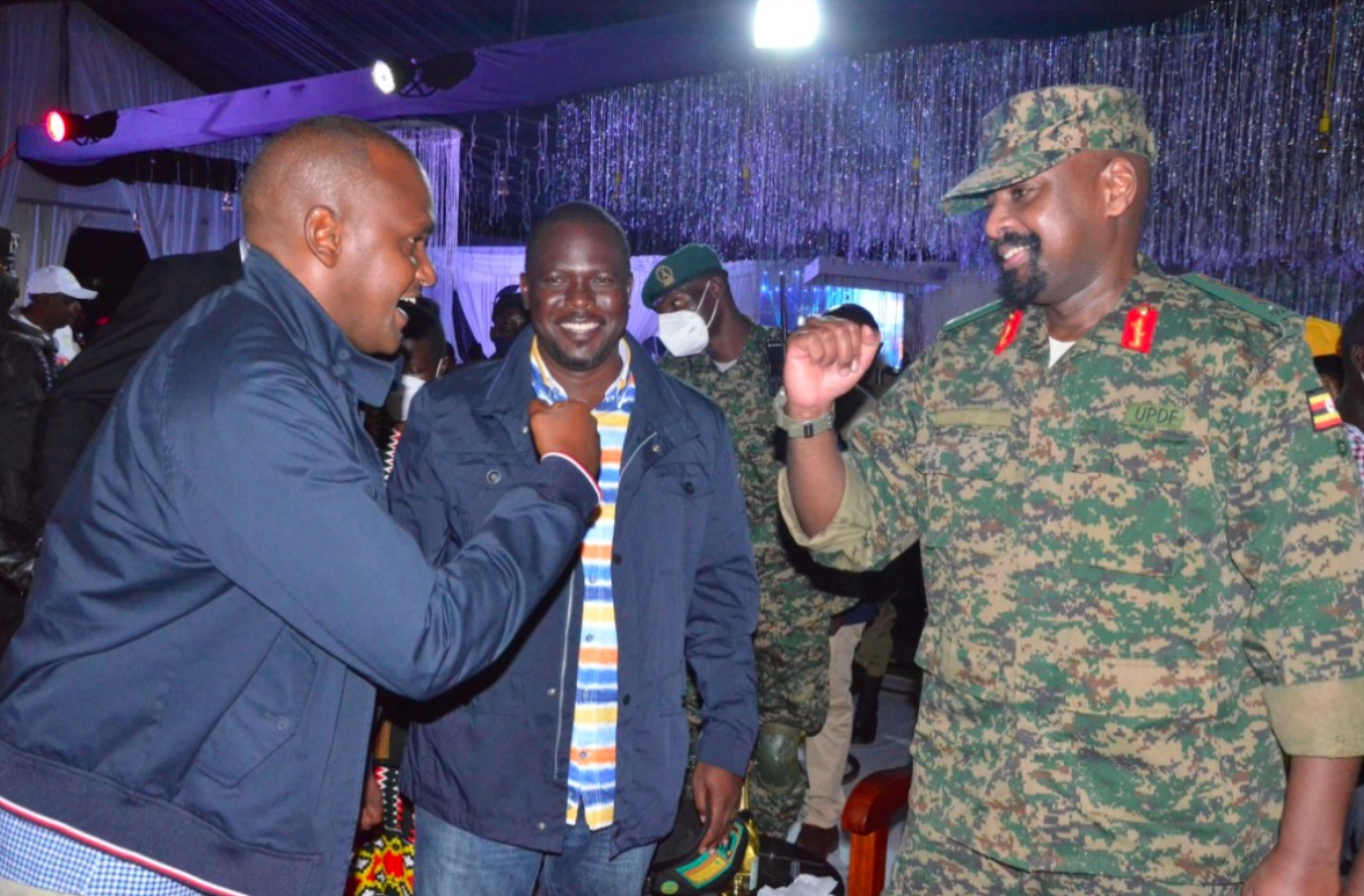 Gen Muhoozi gestures to minister Frank Tumwebaze during his pre-birthday party in Kololo