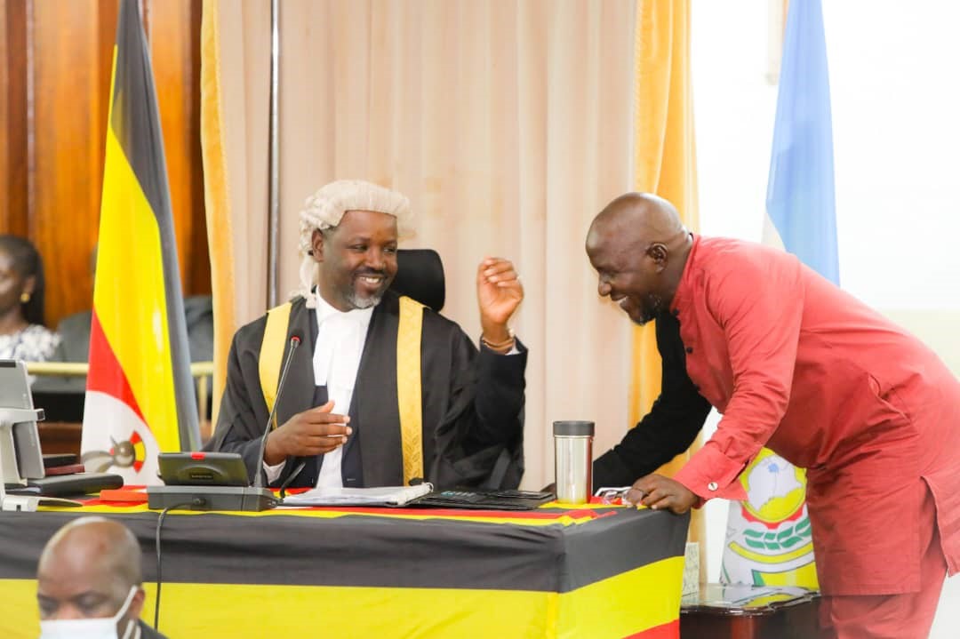 Deputy Speaker, Tayebwa exchanging views with Hon Asuman Basalirwa during plenary