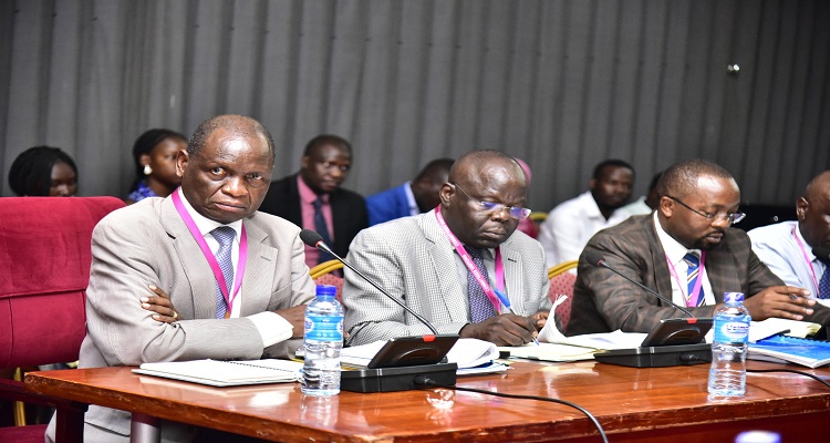 Dr Orem (L) with other officials from the institute before the committee