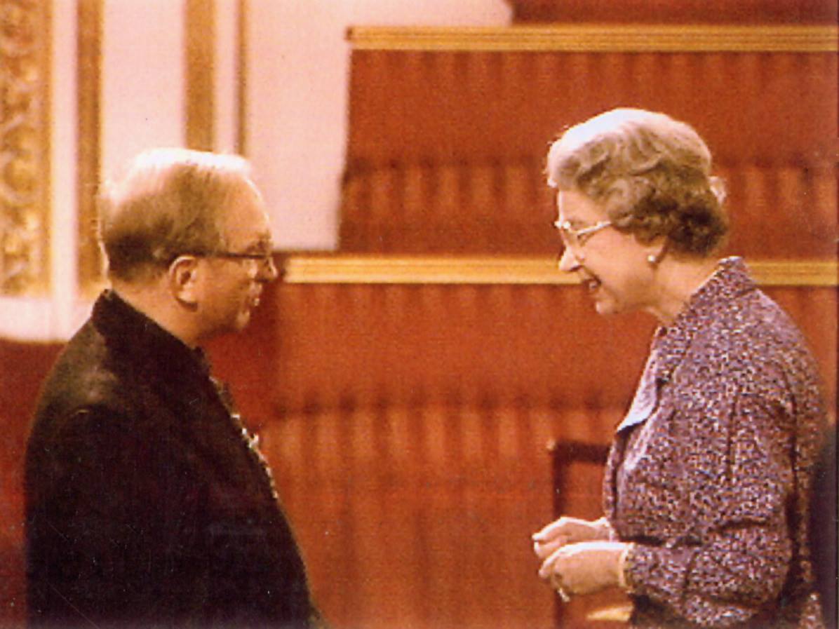 Father Damian Grimes receiving the MBE from Queen Elizabeth II at Buckingham Palace in 1991 for services to education in Africa.