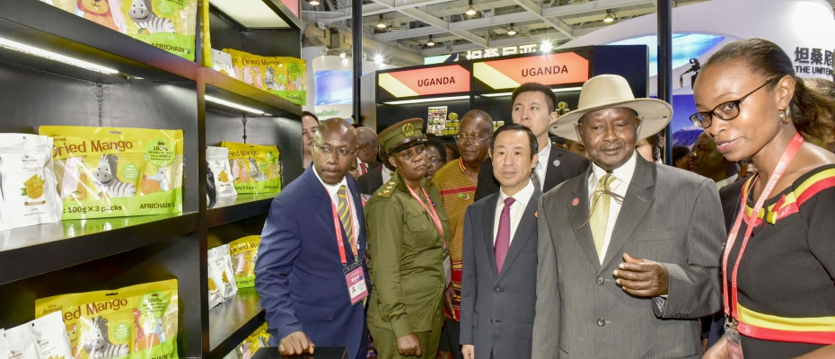 President Museveni chats with Uganda and Chinese officials during a tour of Ugandan stalls at the China-Africa Economic and Trade Expo. PPU photo