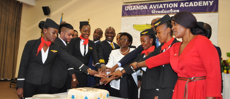 Works minister Monica Azuba and Mike Mukula joins the students to cut a cake at the graduation