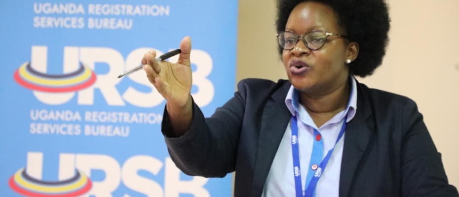 The Registrar General Mercy Kainobwisho gestures during the GI consultative meeting in Kampala