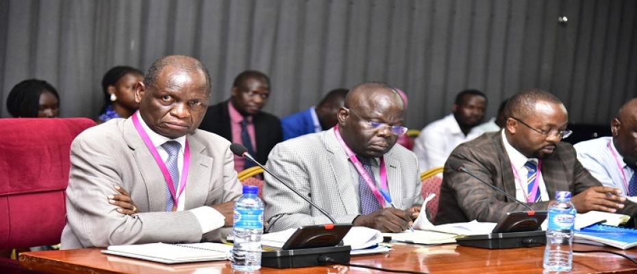 Dr Orem (L) with other officials from the institute before the committee