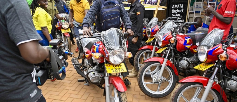 One of the beneficiaries moves away with one of the 36 boda bodas that are going to be received bythe 12 SACCOS in the Kampala Ghetto Structures each receiving 3 bikes 