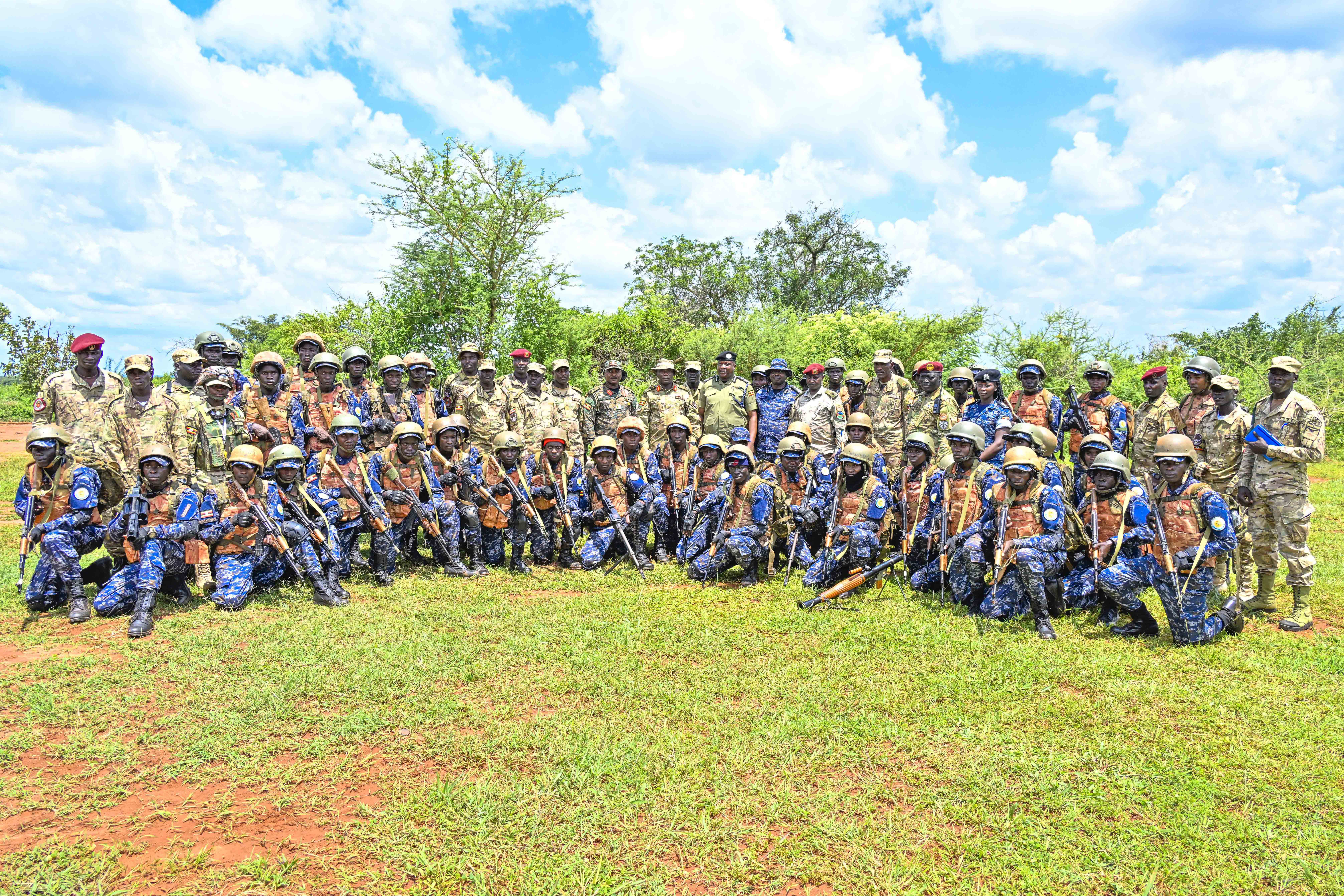 The Chief Guest Chief Of Staff Special Force Command Brig. Gen. Paul Namawa, Director Human Recourse and Development and Training AIGP Moses Kafeero, Commandant Oliver Tambo Reginald leadership School Pan African Centre of Excellency Col. Justus Rukundo, Director of Training and Doctrine – SFC Lt. Col. Paul Micki Lokut, Police Presidential Guard Commander Lt. Col. Collins Kanyesigye, Commandant of Police Presidential Guard  Special Force Training School Fort Samora Machel in Kaweweta Maj. Aloysious Nsobya and Officers in a group photo with PPG Trainees after field demonstrations at Passes out Police Presidential Guard  Special Force Training School Fort Samora Machel in Kaweweta on the 22nd October 2024.