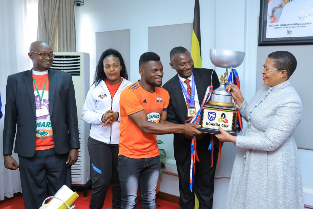 Kitara FC Captain presents the trophy to Speaker Anita Among 