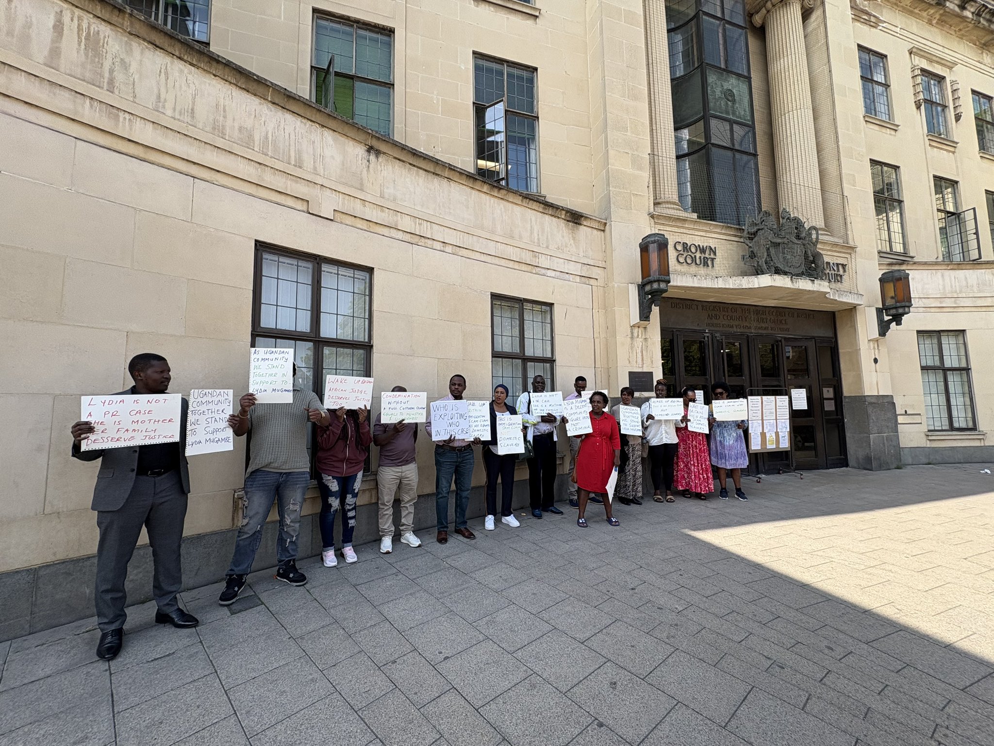 A group of supporters held placards reading “Justice for Lydia Mugambe.